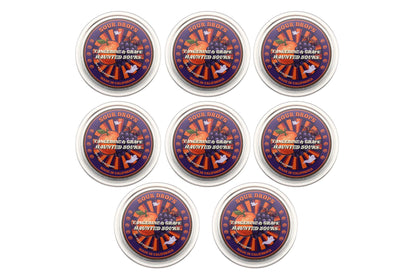 Eight Tangerine & Grape Haunted Sours tins arranged together, the 8-Tin Party Pack of dye-free Halloween sour candy