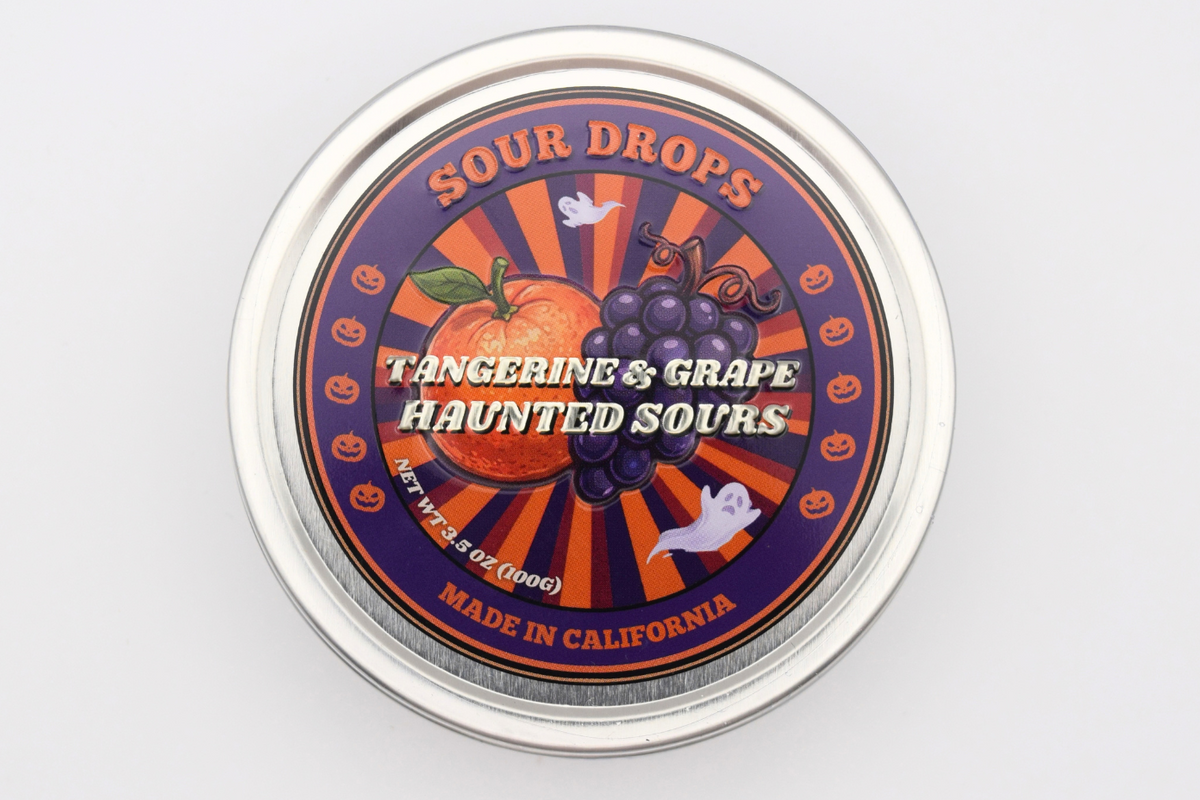 Tangerine & Grape Haunted Sours Halloween tin with tangerine, grapes, ghosts and pumpkins on the lid, made in California